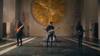 Scott LePage and Tim Henson playing in Polyphia's Playing God music video