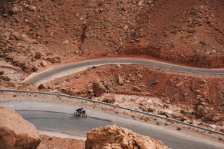 Image shows Anna descending a twisty road in Morocco.
