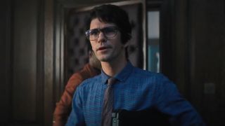 Ben Whishaw tries to hide his excitement while walking into an office in No Time To Die.