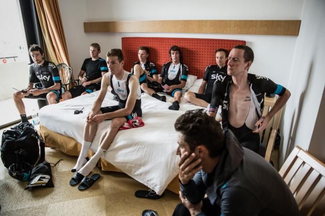 The team gather in a hotel bedroom before stage 3 of the Giro