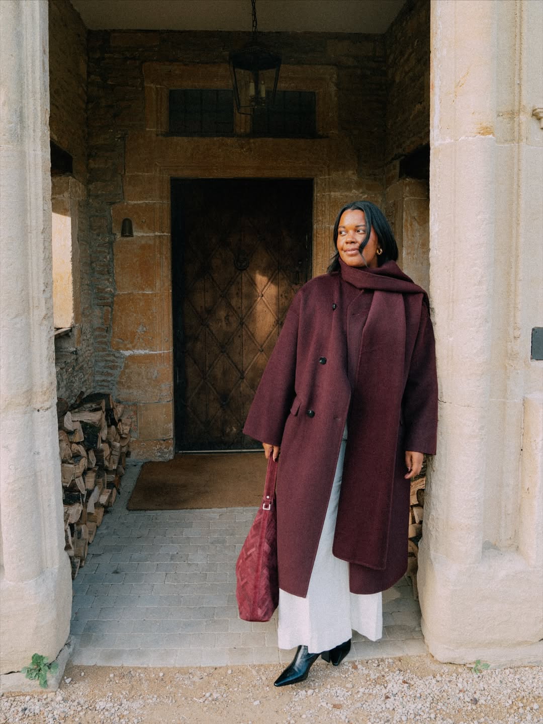 Karina in a burgundy scarf coat