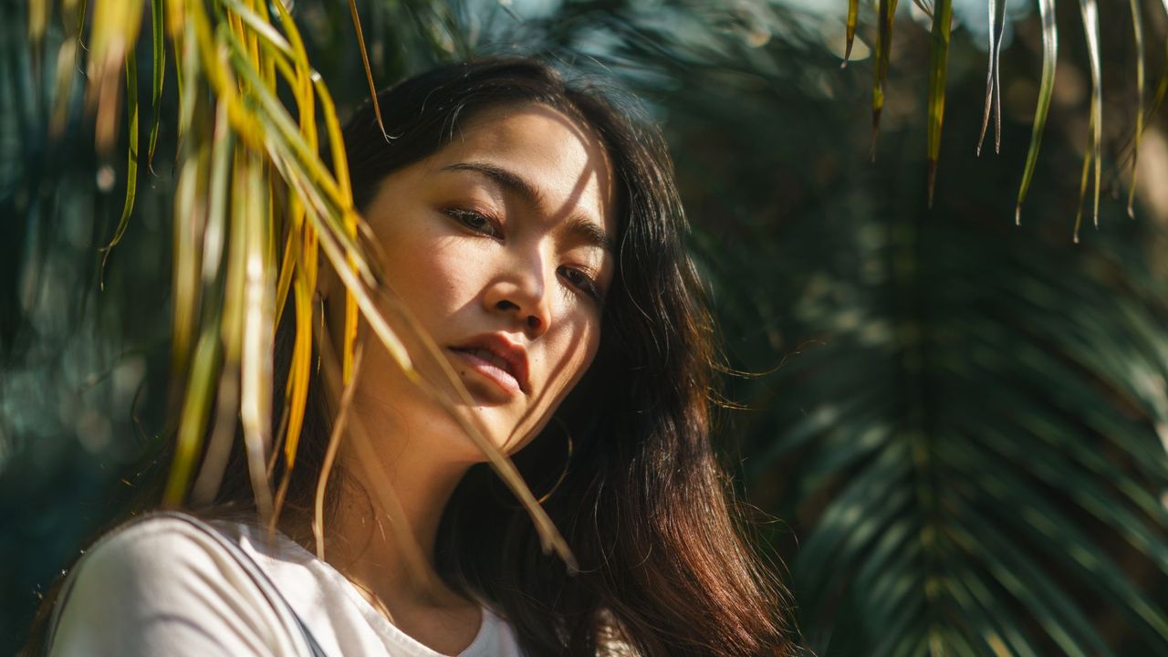 Woman in the sunlight with leaves