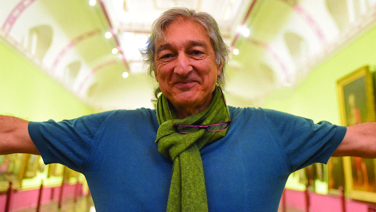 Rega's Roy Gandy standing in an art gallery