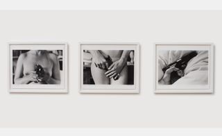 series of three framed photographs of nude woman with gun