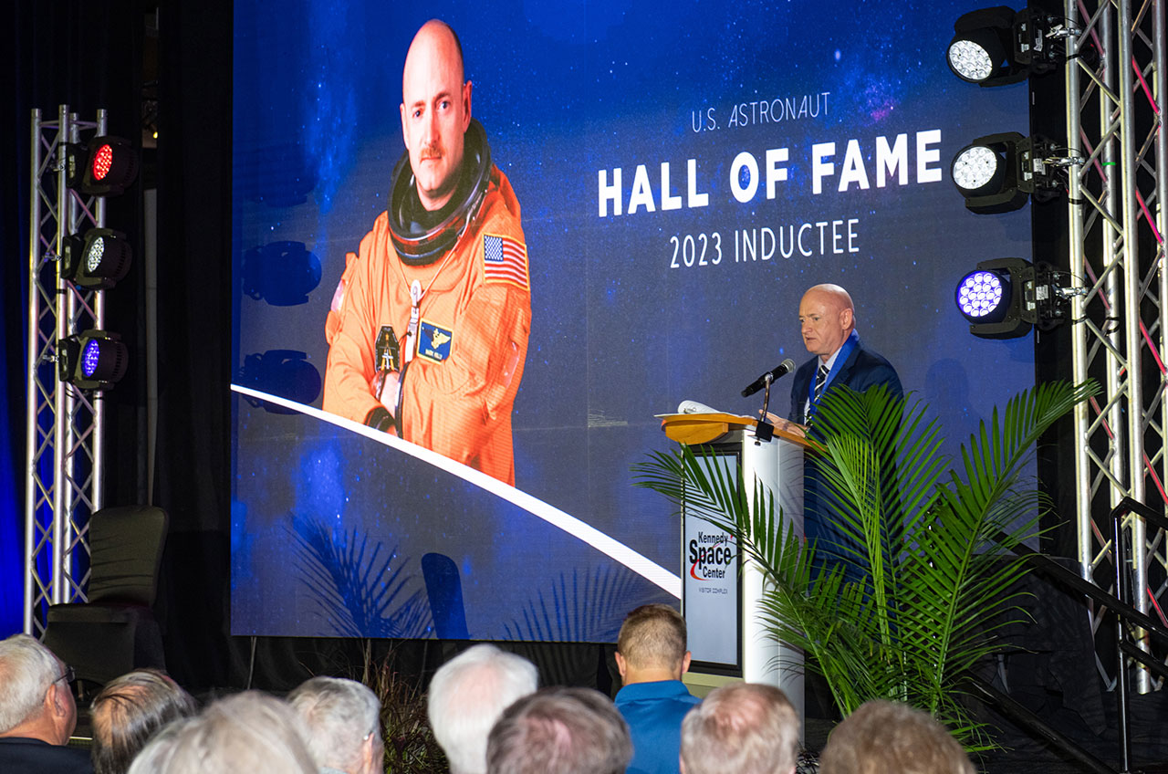 Senator Mark Kelly speaks at his induction into the Astronaut Hall of Fame at Kennedy Space Center Visitor Complex.