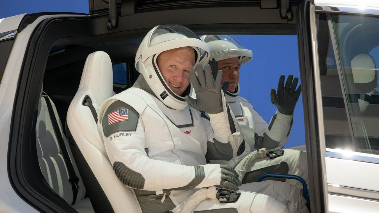 NASA astronauts Bob Behnken and Doug Hurley walk out of NASA's Astronaut Crew Quarters and take a Tesla Model X to Launch Pad 39A during a dry-run test of their SpaceX Crew Dragon Demo-2 flight on May 23, 2020 at the Kennedy Space Center in Florida.