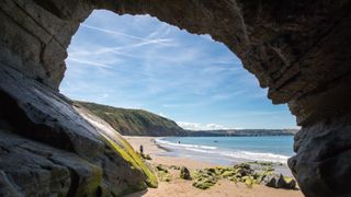 Cave on the sandy beach in Penbryn, Cardigan Bay, Wales. Taken on a sunny day when the beach was empty. 