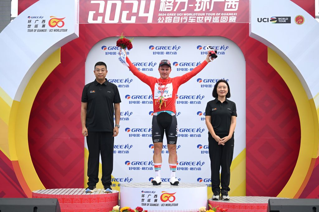 FANGCHENGGANG CHINA OCTOBER 15 Lionel Taminiaux of Belgium and Team Lotto Dstny celebrates at podium as Red Leader Jersey winner during the 5th GreeTour Of Guangxi 2024 Stage 1 a 1493km stage from Fangchenggang to Fangchenggang UCIWT on October 15 2024 in Fangchenggang China Photo by Dario BelingheriGetty Images