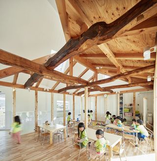 Exposed wooden beam structure inside kindergarten