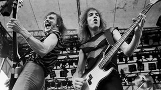 German Rock musicians Rudolph Schenker (left), on guitar, and Francis Buchholz, on bass guitar, both of the group Scorpions, perform onstage at the Rockford Speedway, Rockford, Illinois, July 27, 1980.