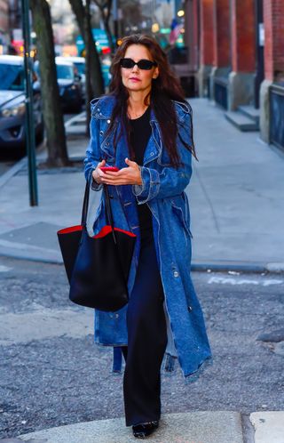 Katie Holmes wearing denim trench coat, jeans, and a black top