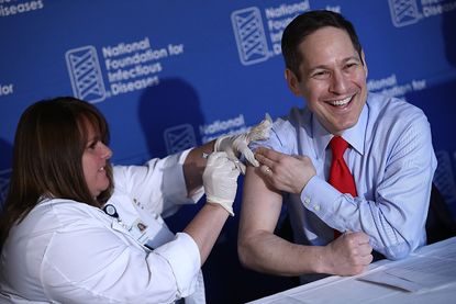 CDC Director Dr. Thomas Frieden gets a flu shot on Thursday.