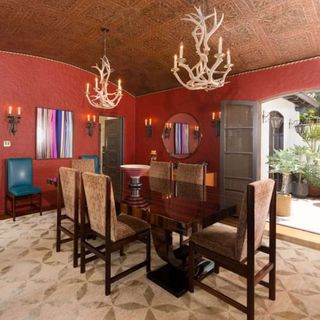 dining area with red wall and dining table