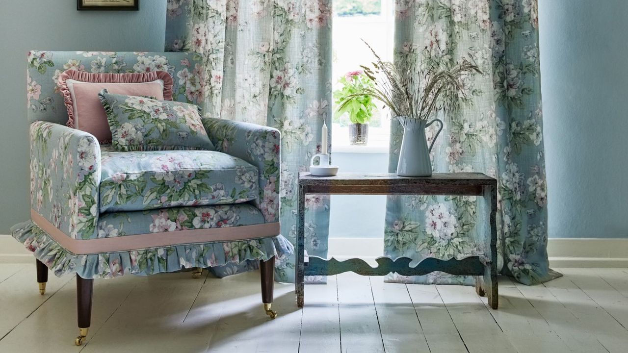 Blue armchair in front of matching blue drapes