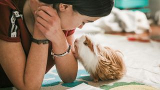 Woman and guinea pig