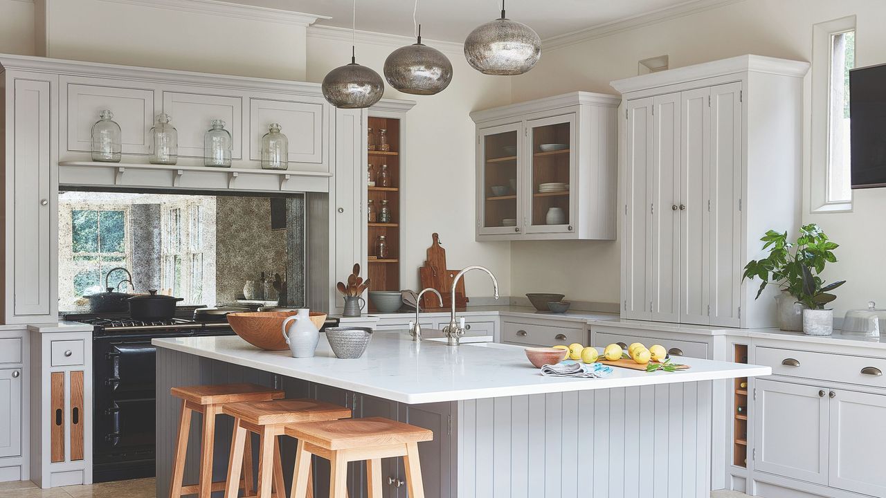 A kitchen island with pendant lighting above