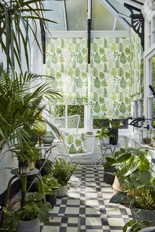 glazed conservatory with botanical blinds and lots of plants