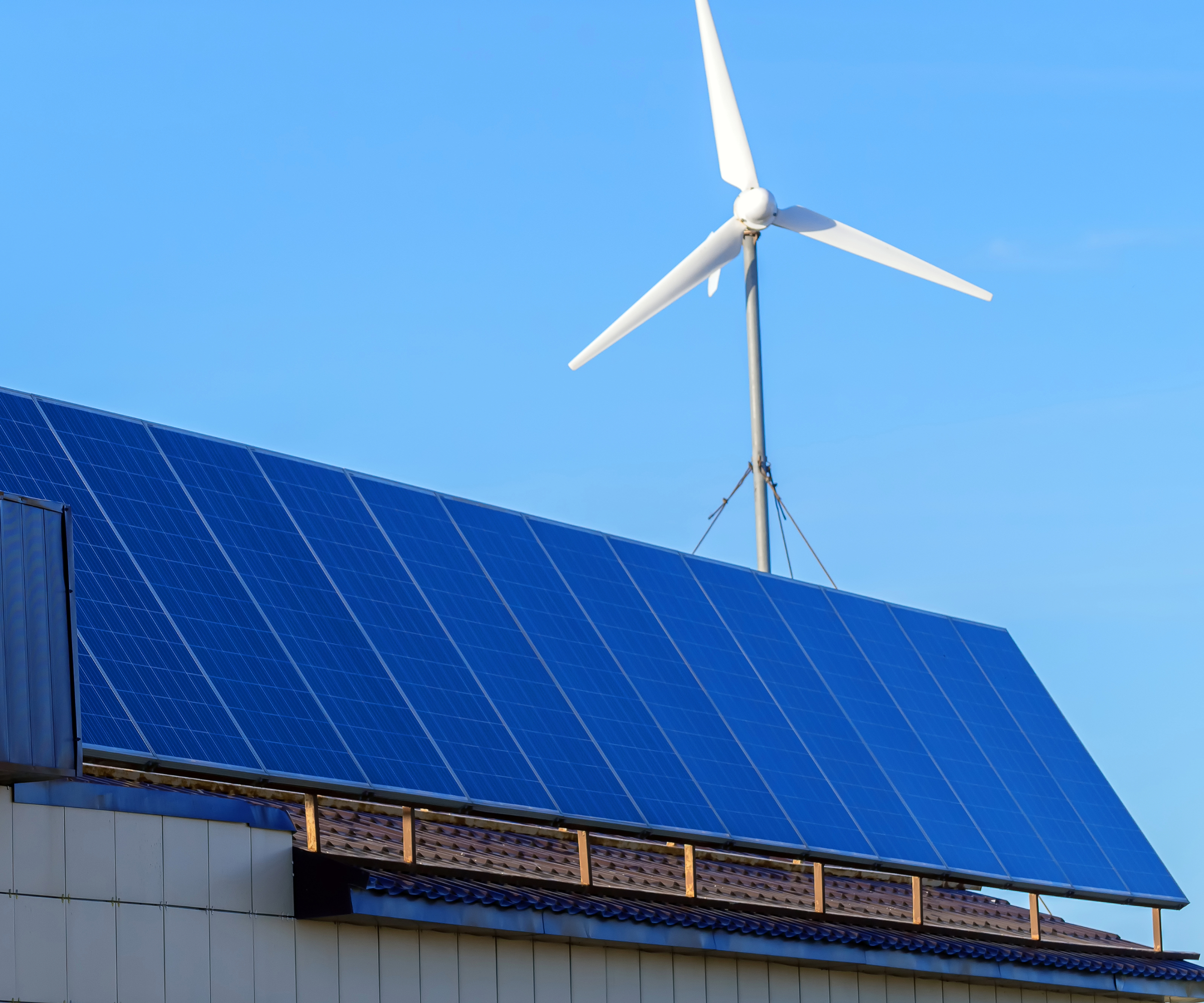 Solar panel and wind turbine on a roof