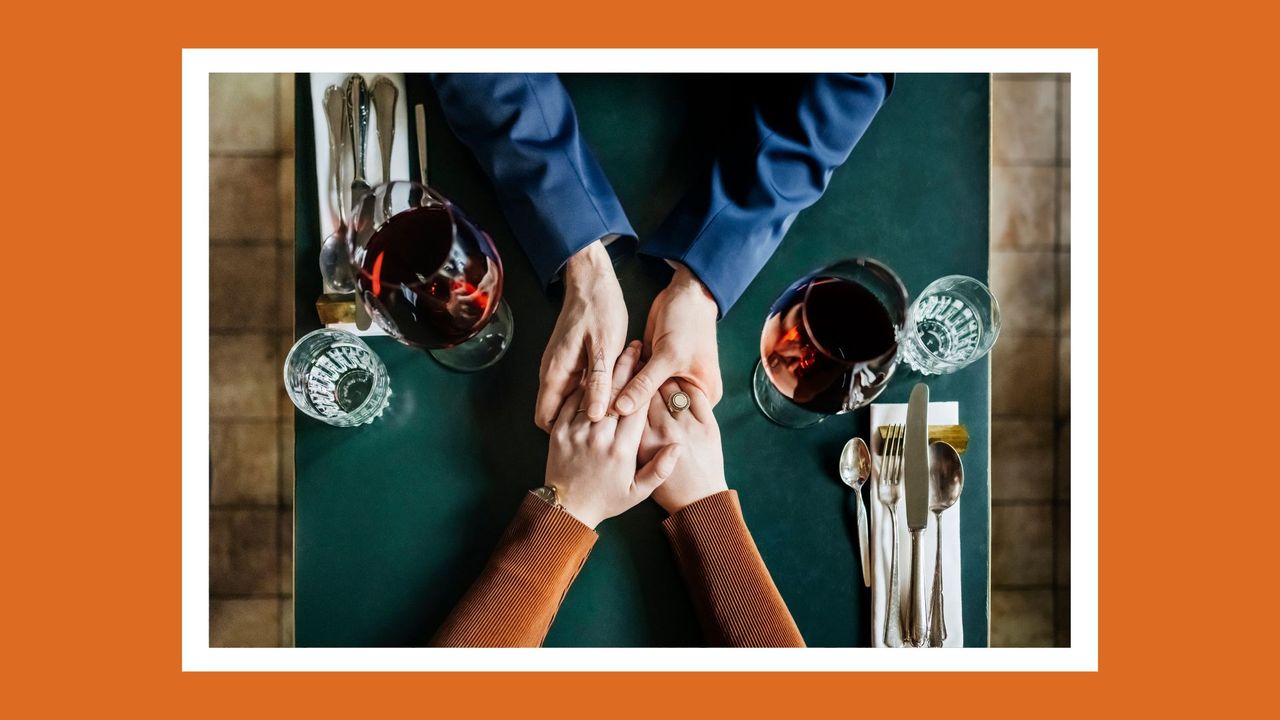 aerial shot of a couple holding hands at a restaurant table