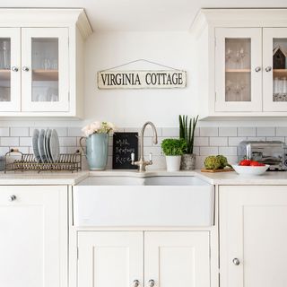kitchen area with white wall and white kitchen cabinet