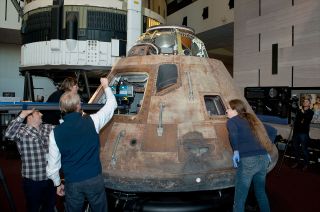 National Air and Space Museum staff work with the Smithsonian's Digitization Program 3D scanning team on capturing the interior of the Apollo 11 command module.