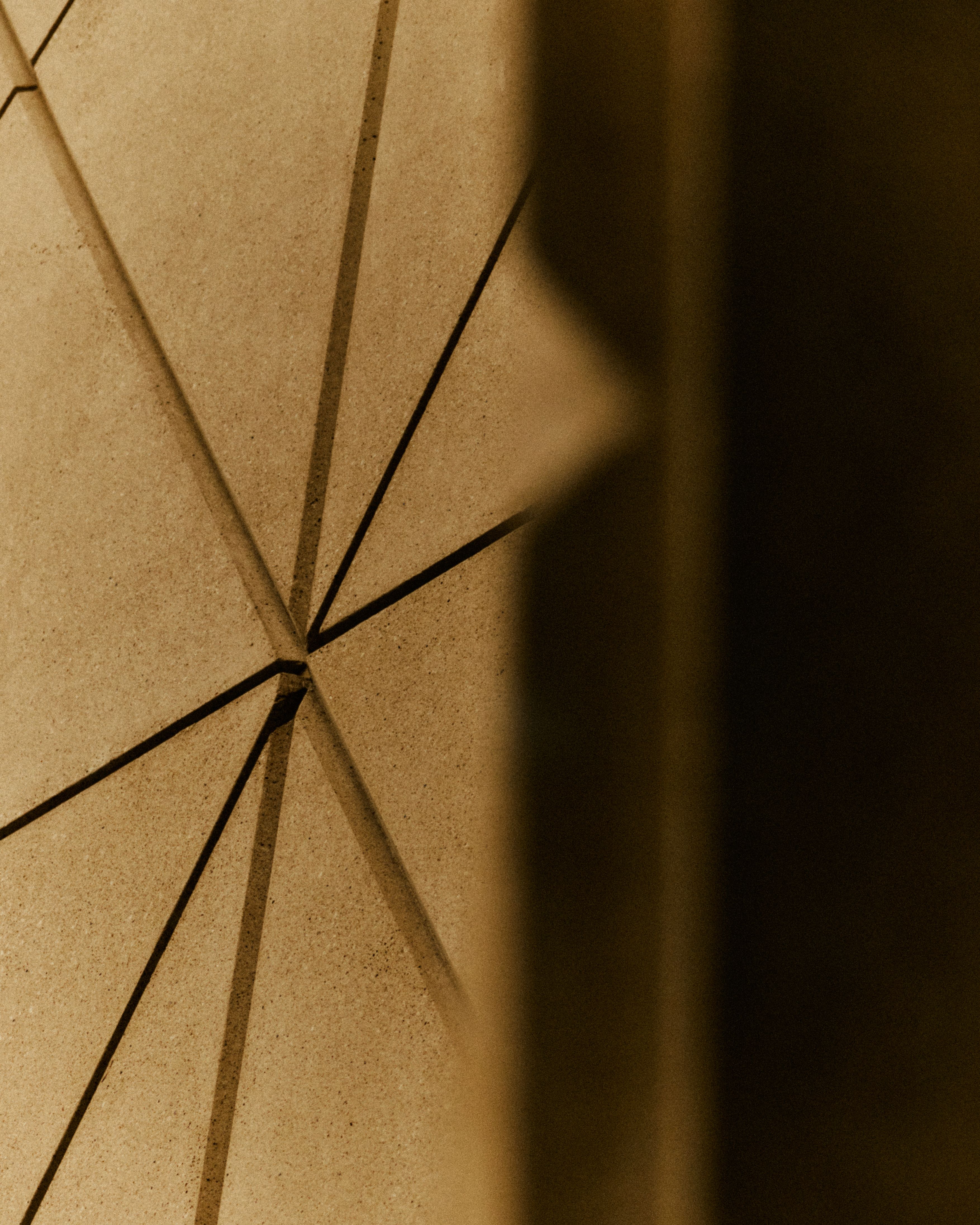 Exterior view of a geometrically shaped museum facade with multiple cement slabs combined into an angular shape, with a white sign that reads, in caps, "V&amp;A".