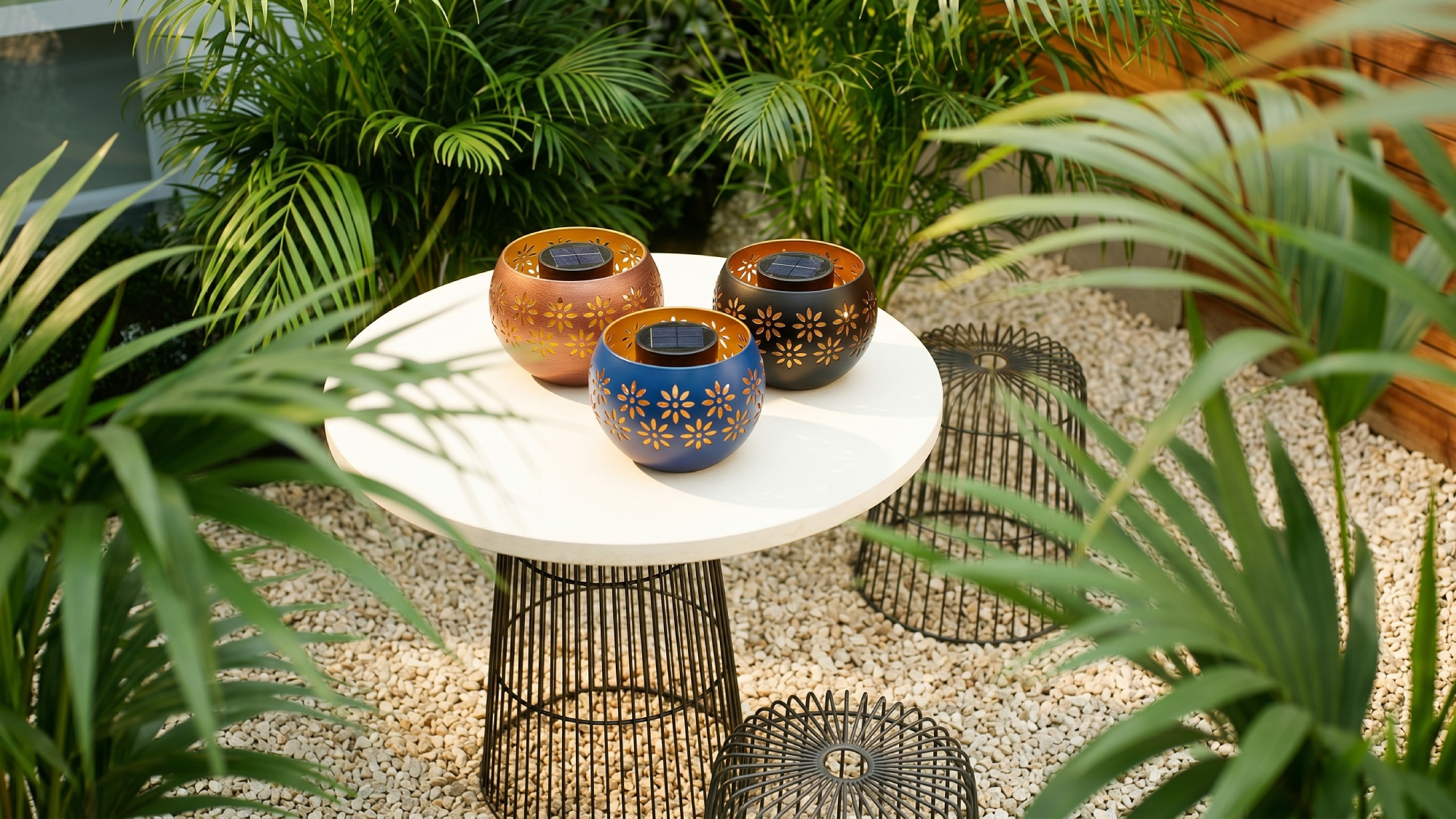 ALDI's Belavi solar fire bowl on a small table in a modern garden