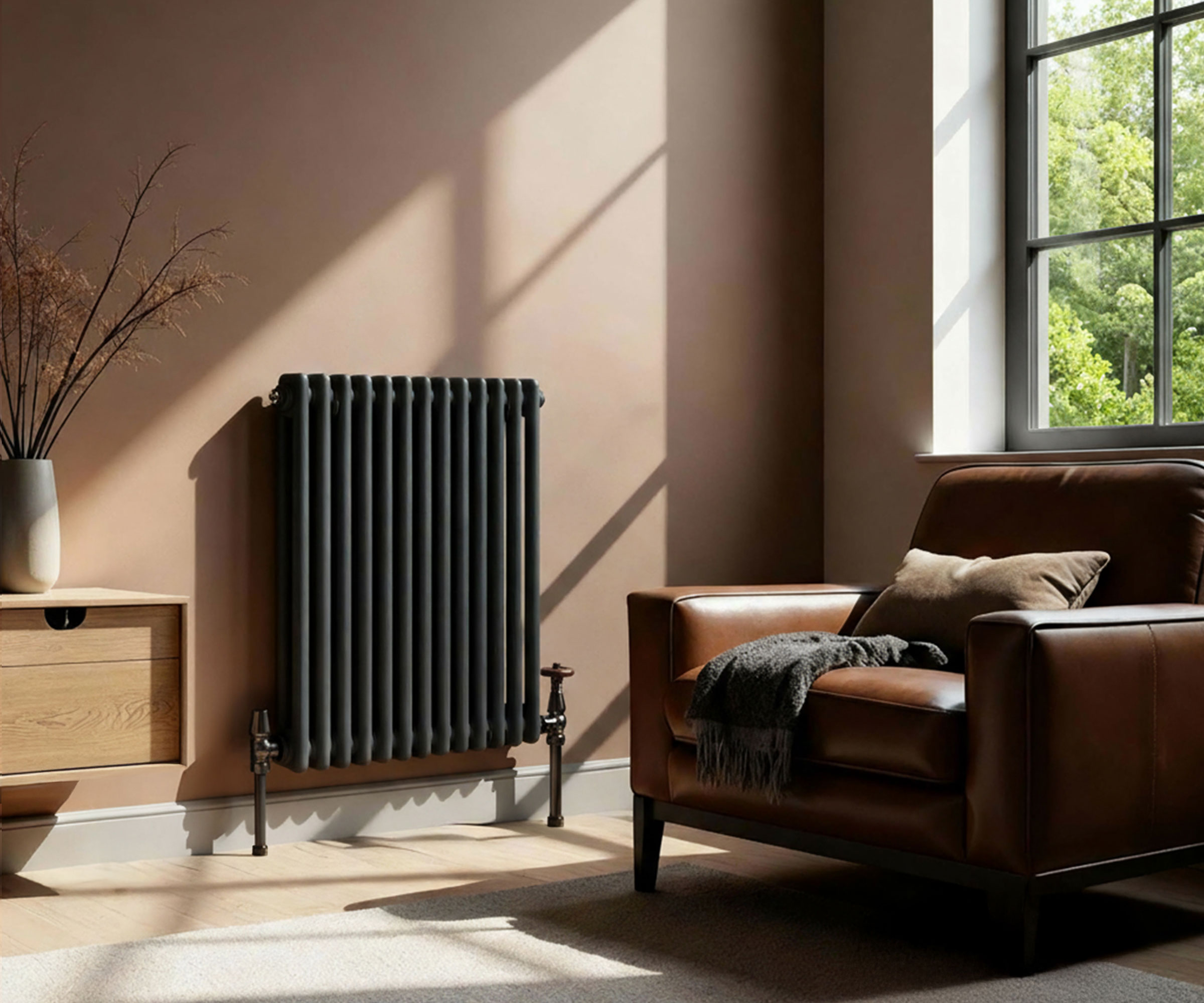 black column radiator in living rom with pale brown walls and leather armchair