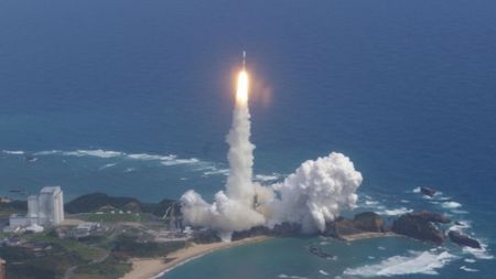 A white and yellow Japanese rocket launches the Kaguya spacecraft to the moon on Sept. 13, 2007.