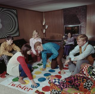 Family in the 1970s playing twister