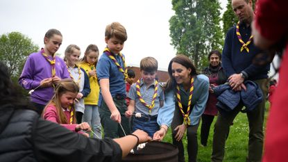 The Wales family roasting marshmallows with Scouts