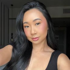 A woman taking a selfie with glowing skin