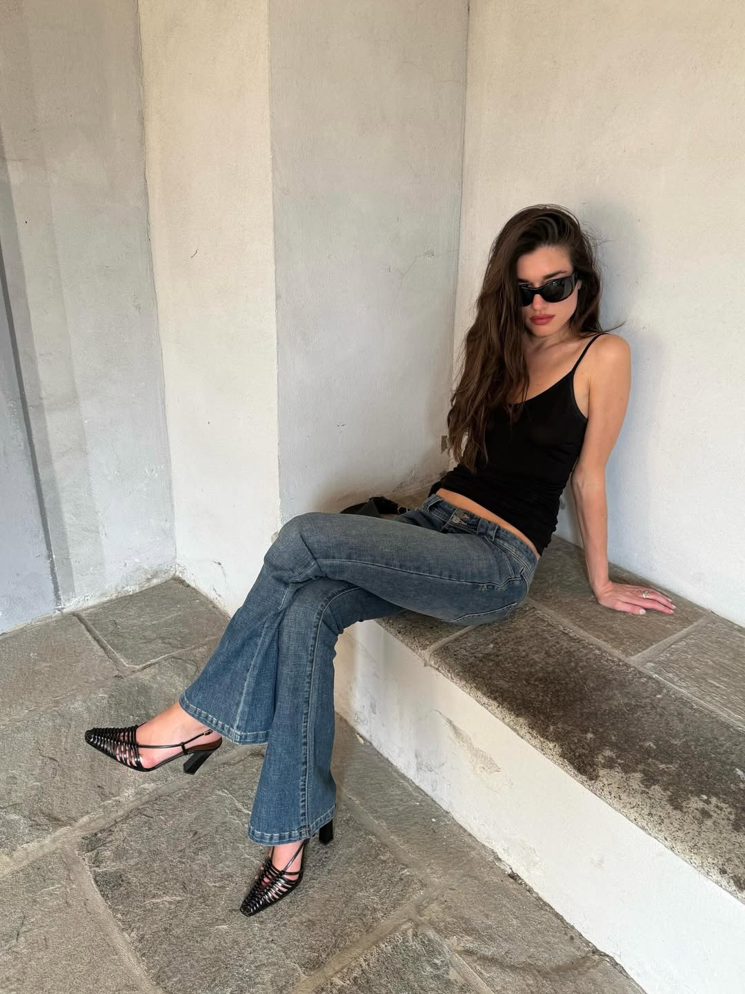 Ilirida in low-rise jeans and black vest