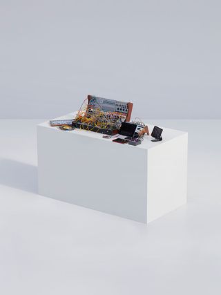 White block table with electrical items and wires on