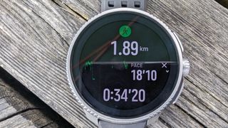 Suunto Race on a table outdoors in the sunlight.