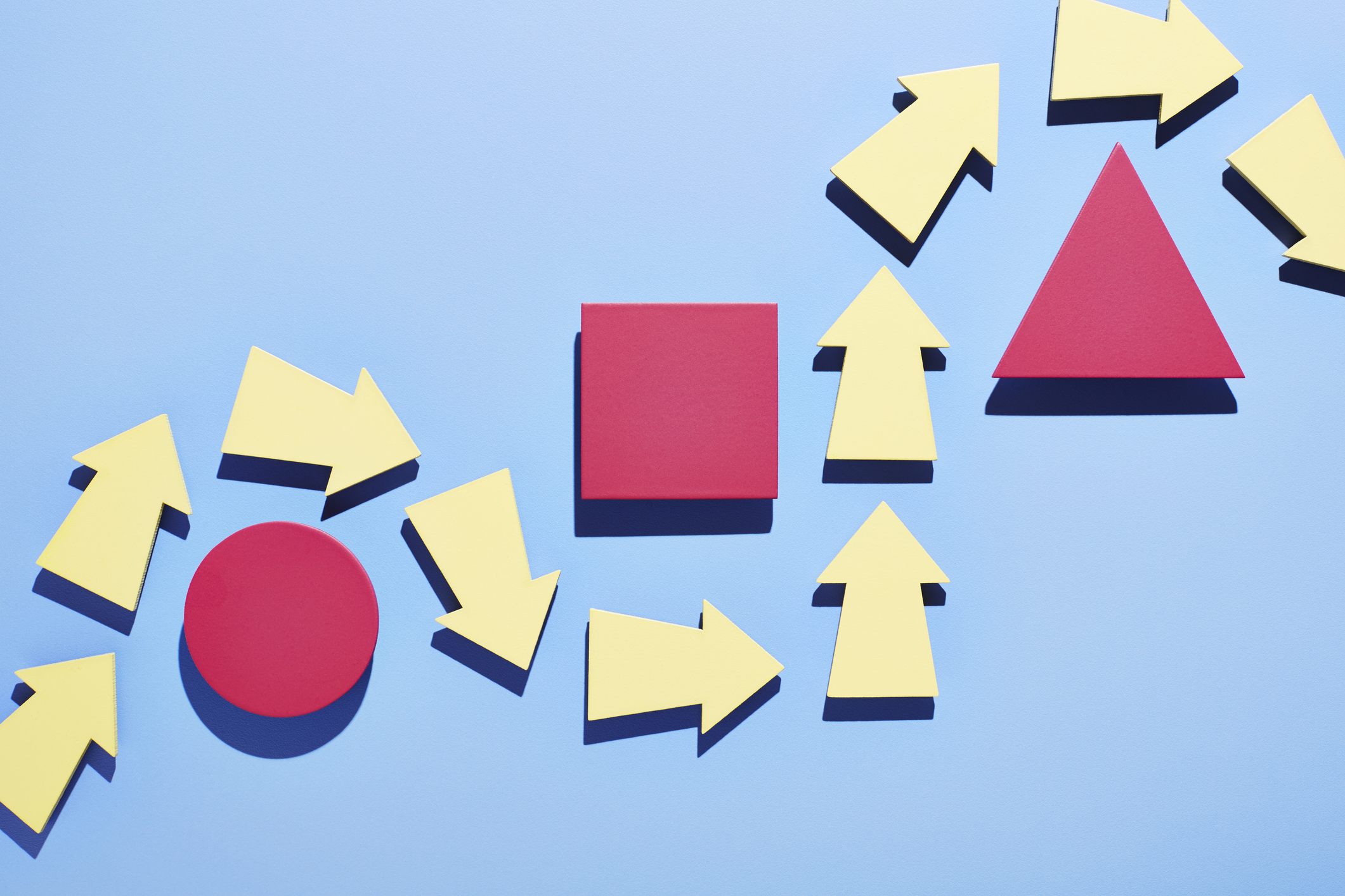 A group of arrows moving around obstacles in their path - stock photo