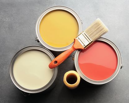 Living room paint finishes with three paint cans