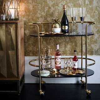 drinks trolley with champagne glasses and bottle