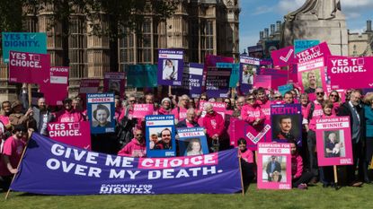 Campaigners from Dignity in Dying organisation take part in a rally outside Houses of Parliament in support of assisted dying, April 2024