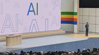 Sundar Pichai at Google IO 2024 with a giant AI graphic in the background