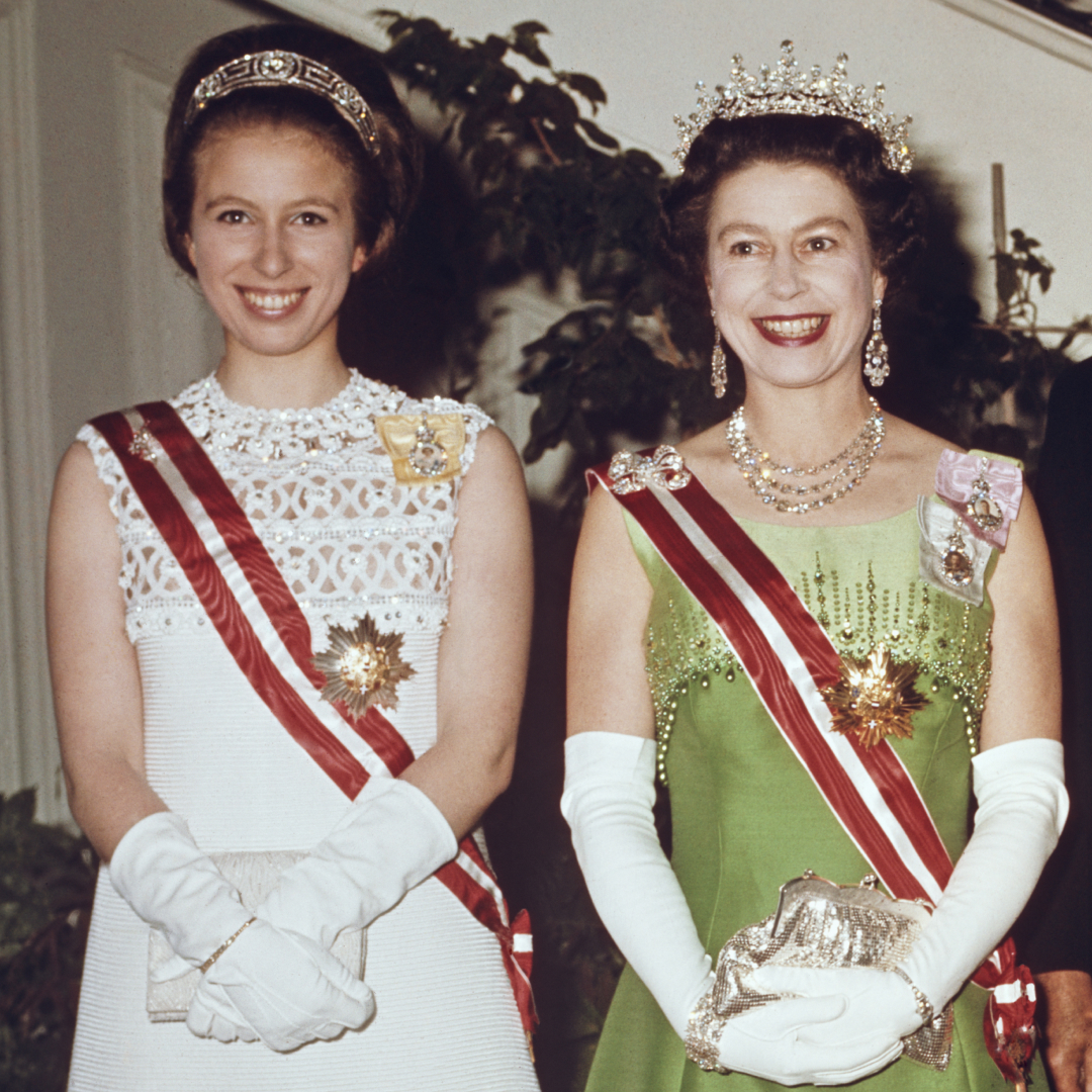 Princess Anne and Queen Elizabeth wearing tiaras and evening gowns smiling