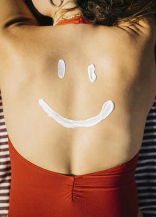 Person with sunscreen on their back