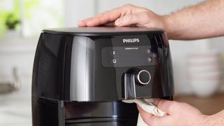 Philips air fryer being wiped