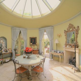 dining area with yellow wall and round dining table