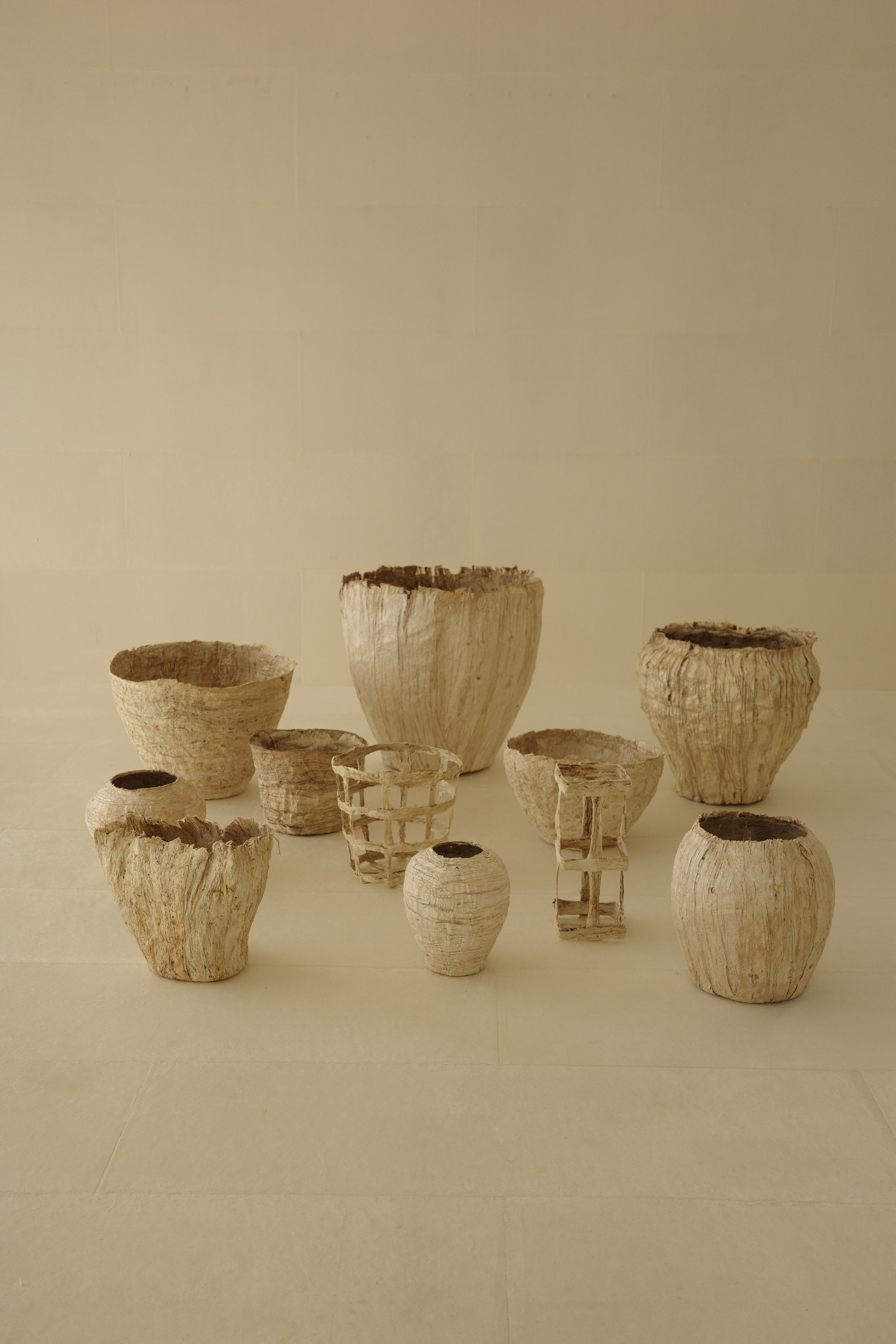 Washi paper vessels by Naowashi on beige background