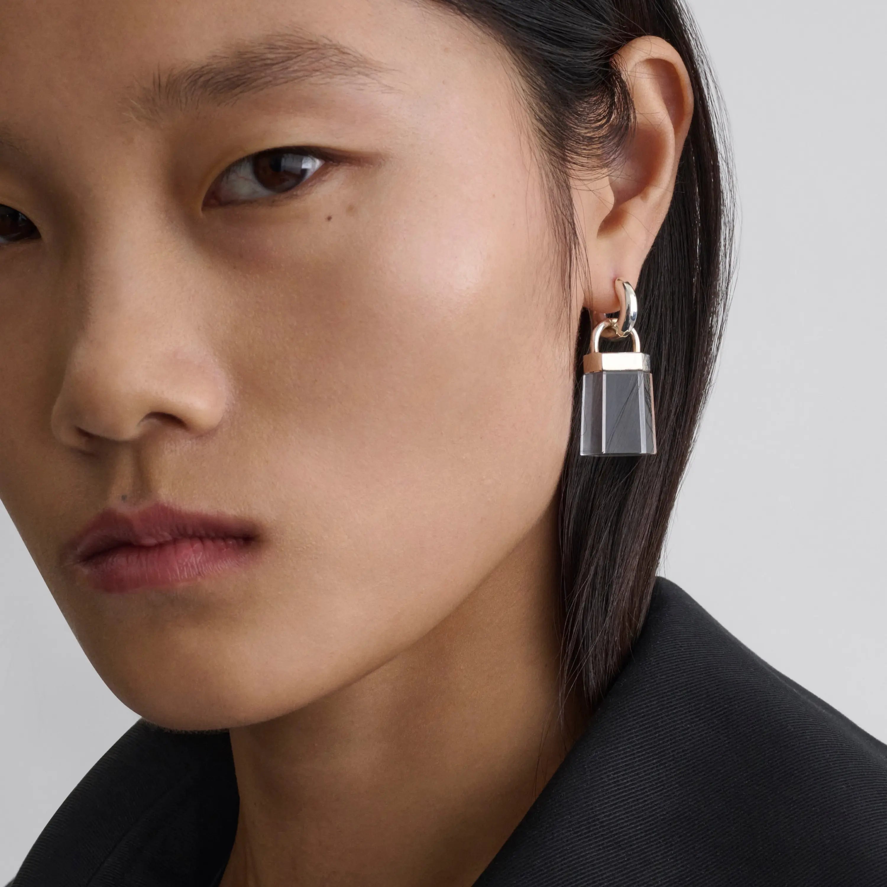 a model wearing phoebe philo resin and silver earrings