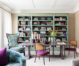 home office with teal shelves and purple cushions