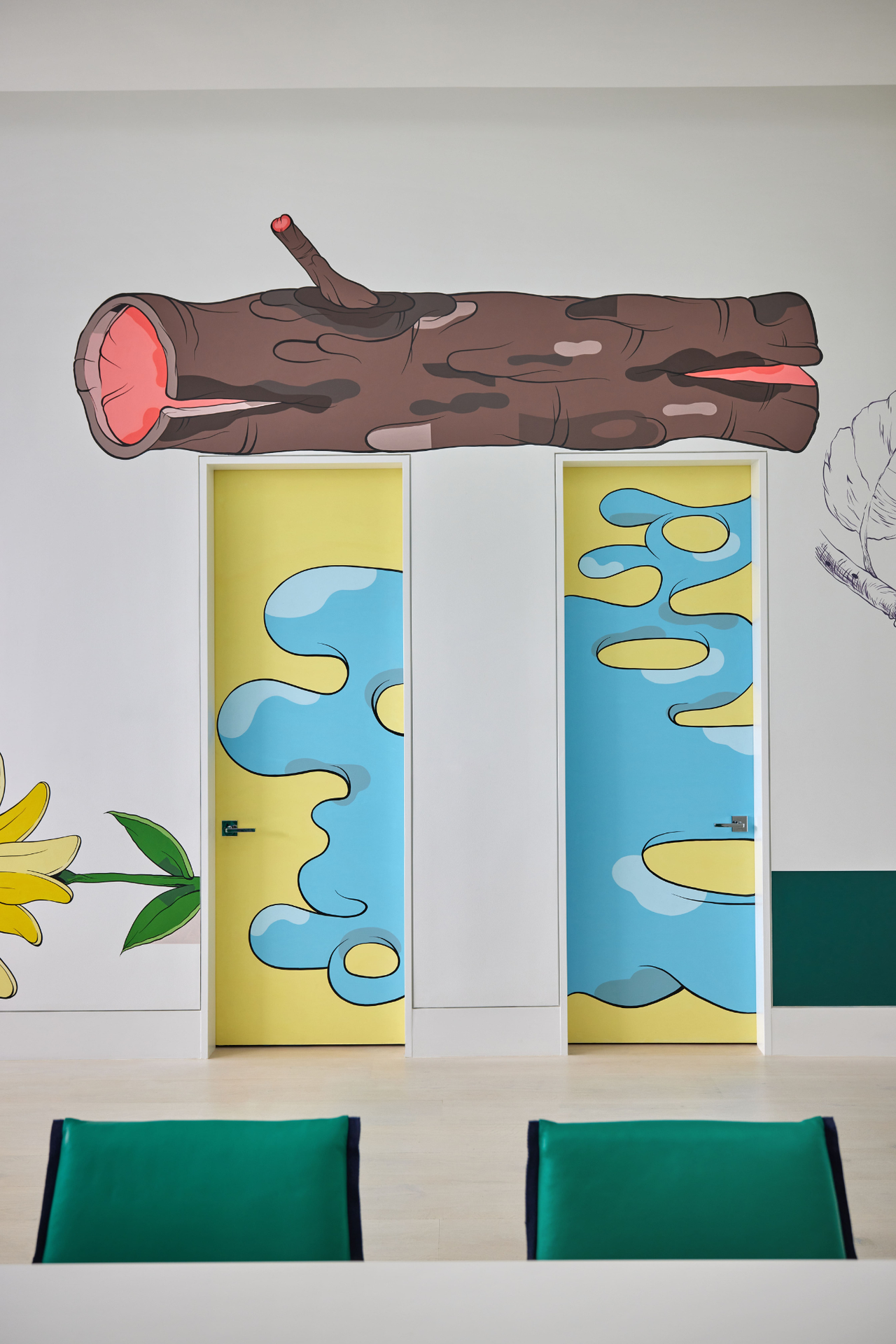 colorful Tribeca townhouse designed by Ghislaine Vi&ntilde;as with two doors painted in a bright yellow and blue design with a tree trunk image above and two green seats in the foreground