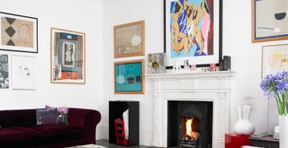 White living room with artwork on all walls to highlight living room design mistakes