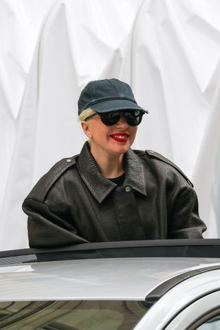 lady gaga photographed in Paris wearing a green baseball cap and oversize leather jacket